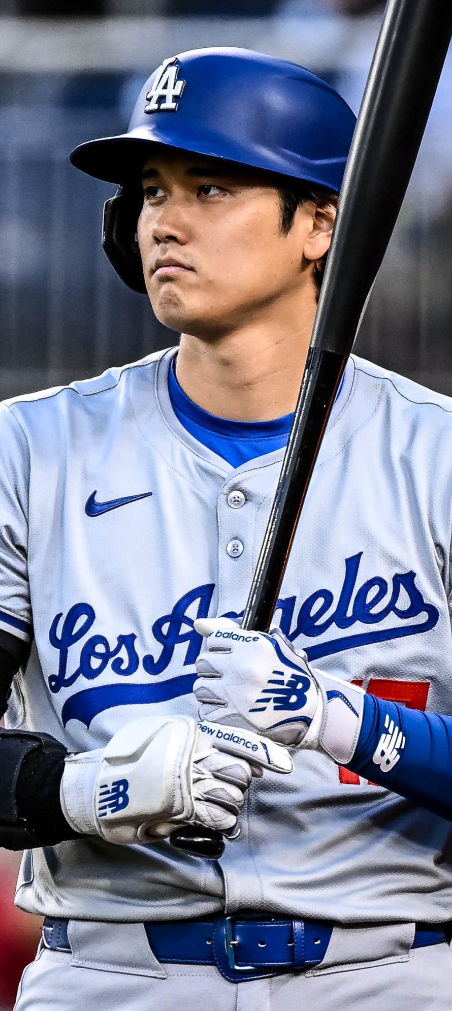 Shohei Ohtani in Los Angeles Dodgers baseball uniform holding a bat
