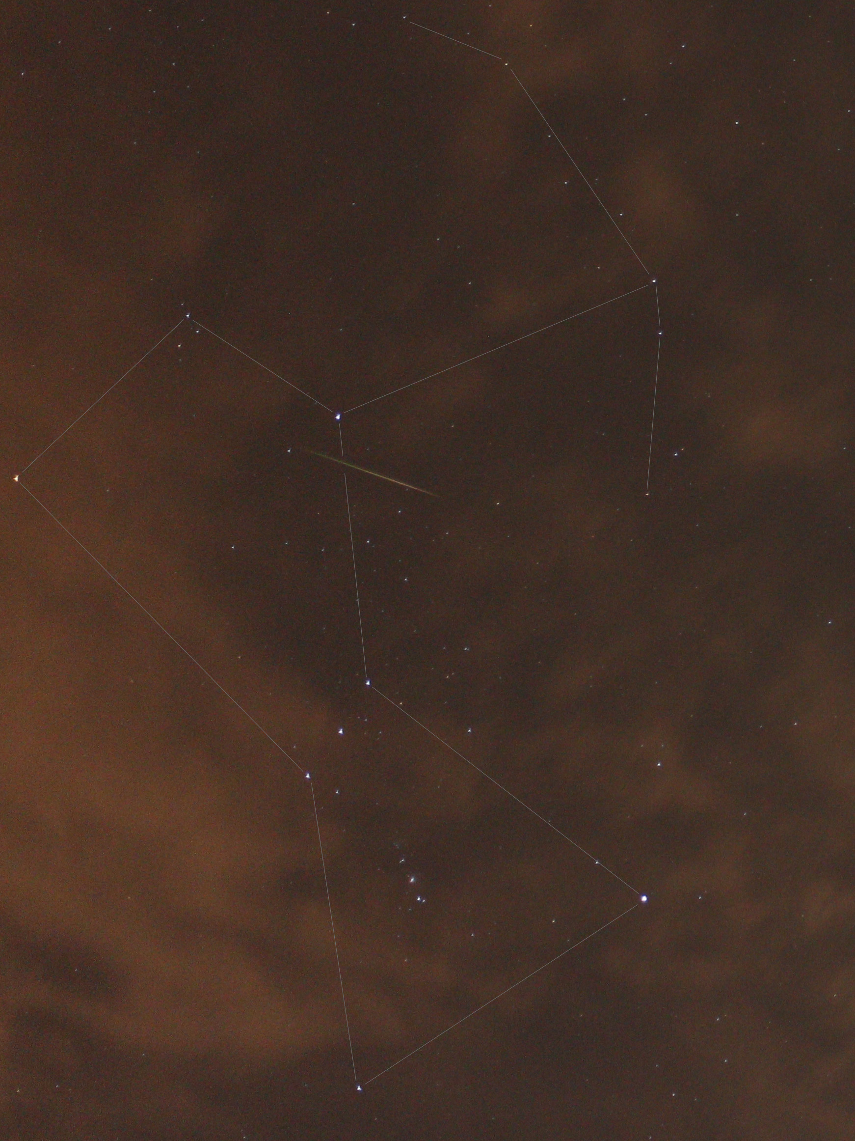 Night sky with stars, Orion constellation outlined, a meteor streak visible.