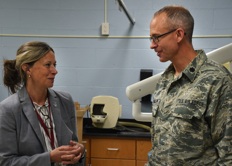Amy Acton speaking with a U.S. Air National Guard officer in a professional setting.