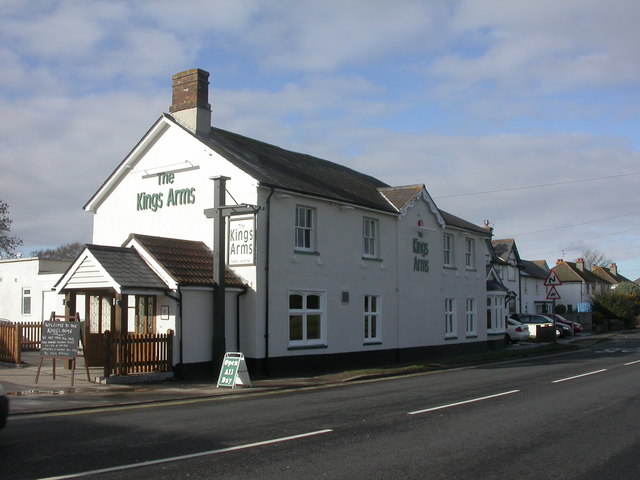 Exterior view of The Kings Arms pub building on a street with signage and a small fenced entrance area