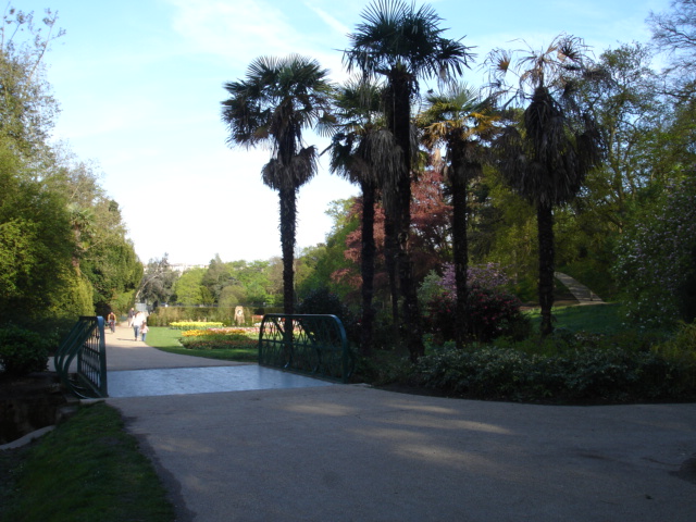 Pathway and bridge with palm trees and gardens in Alexandra Park, Hastings, East Sussex