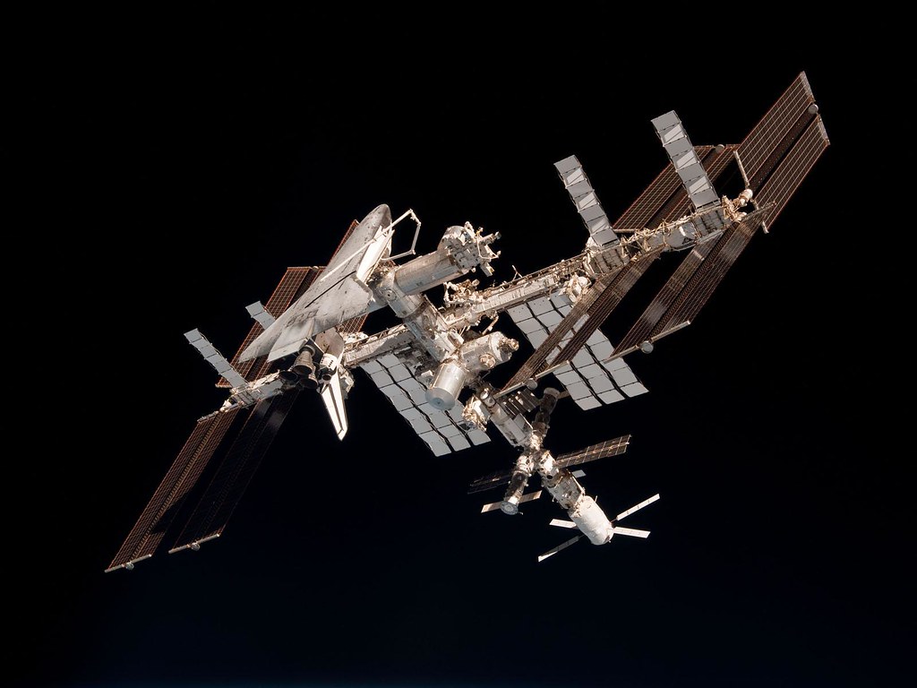The International Space Station with the docked Space Shuttle Endeavour against the blackness of space.